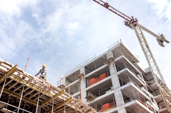 A person on a ladder on a building under construction

Description automatically generated with low confidence